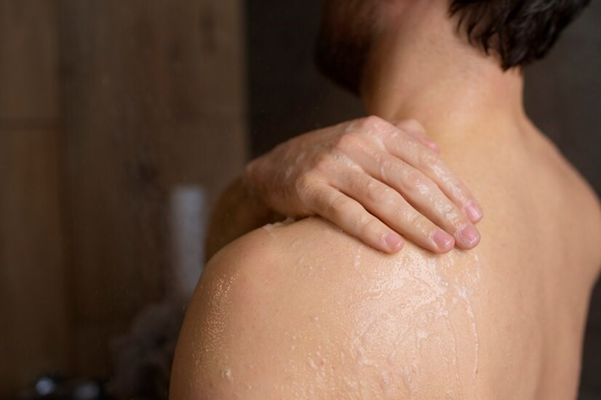 Person scratching their back after a shower