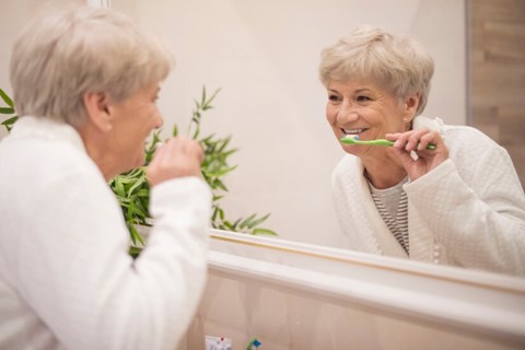 A woman brushing teeth