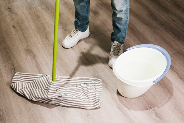 A man mopping the floor