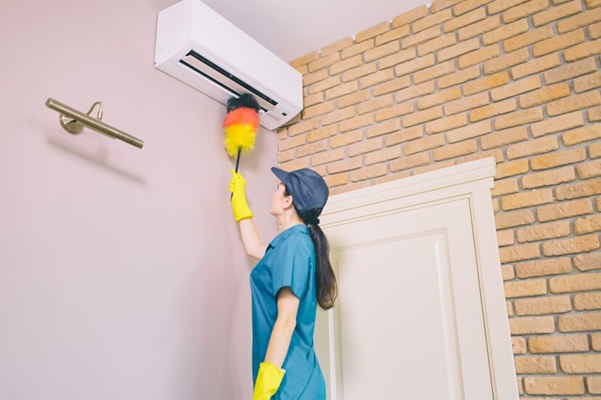 Woman cleaning aircon